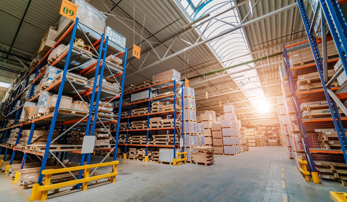 Warehouse storage of a retail goods store. Rows of shelves with boxes